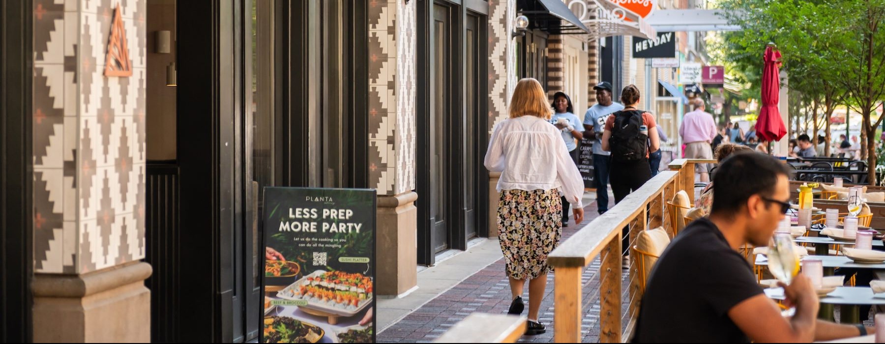 people walking on a sidewalk
