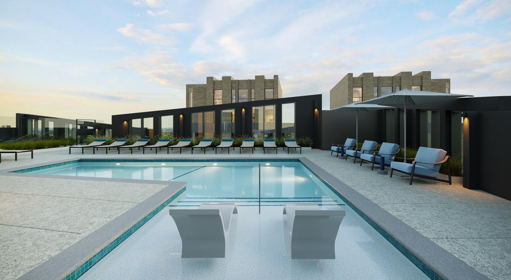 a swimming pool with chairs around it